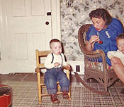 memoir, memoir writing Mom (pregnant again) coaxing Doug as he sits in the rocking chair, 1959